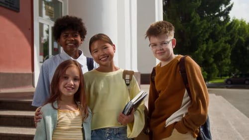 Group Portrait of Multiethnic Smiling Middle-School Children Outside School