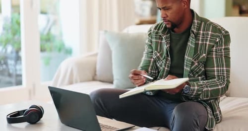 Black man, laptop and writing in notebook at house for remote work, schedule planner