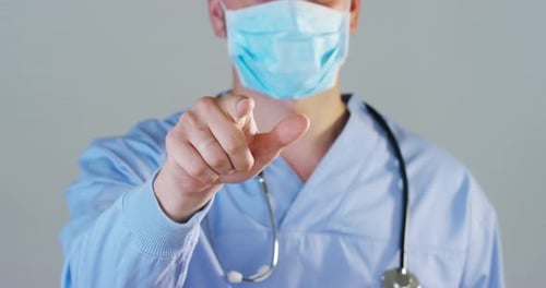 A futuristic doctor, a surgeon, looks into a technological digital holographic monitor, a brain ho