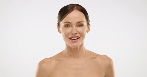 Woman Smiling in Front of a White Background