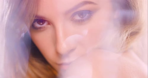 4k video footage of a young woman seductively posing against a studio background