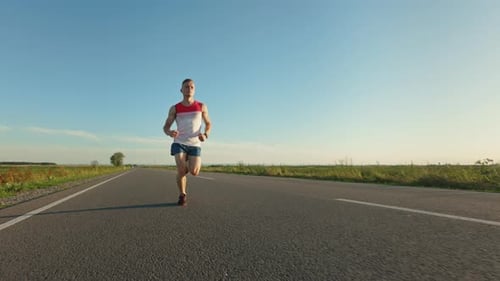 Strong Male Athlete Running Training Endurance in Road in Summer