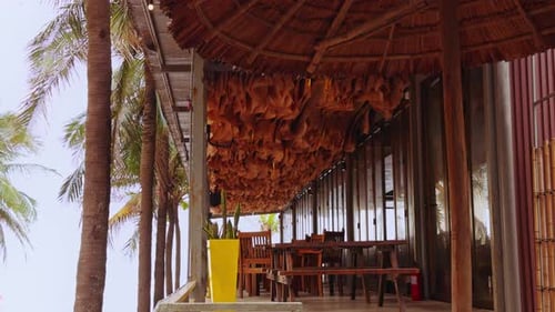 Low Angle Slow Motion View of Beachside Terrace with Waving Ceiling Fabric Moving like Soft Ocean
