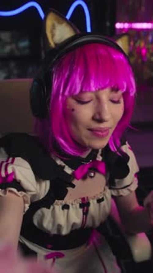 Young Adult with Pink Hair Talking to Camera