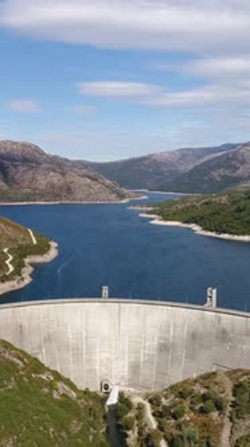 Vertical Video of Hydroelectric power station surrounded with mountains