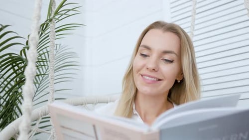Woman Reading Book in Relaxing Environment