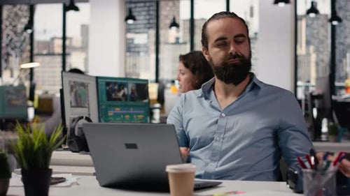 Businessman Working with Focus Music on His Headphones at the Office