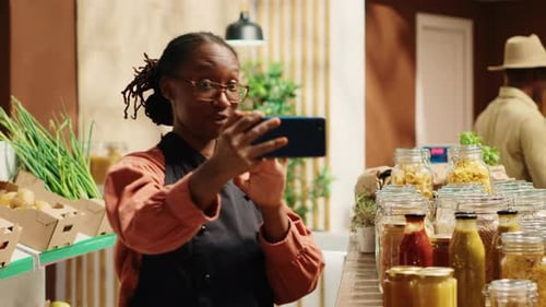 Zero Waste Store Employee Filming Their Natural Products in Recyclable Jars