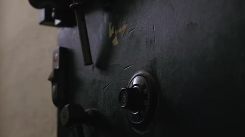 Close up tilt up video of Vintage black metal chest in a dark lift room.