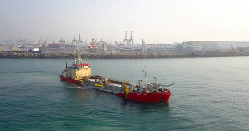 Red and White Harbor Tugboat Sailing on the Sea
