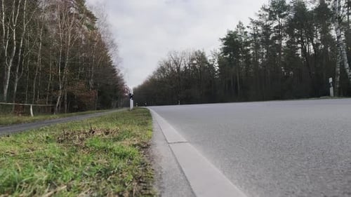 Slider Shot of Motorcycle Passing By on Road in Northern Germany