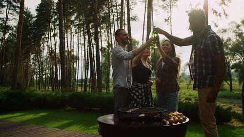 Happy multi ethnic friends cooking bbq vegetables on grill party outdoors
