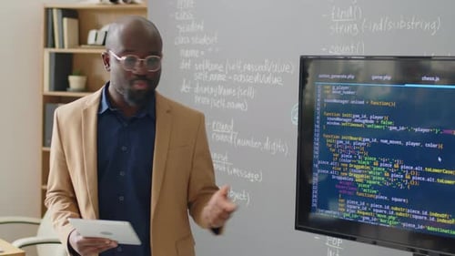 Male Teacher Giving Lecture on Programming
