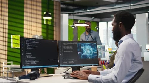 Man Coding at Computer in Modern Office