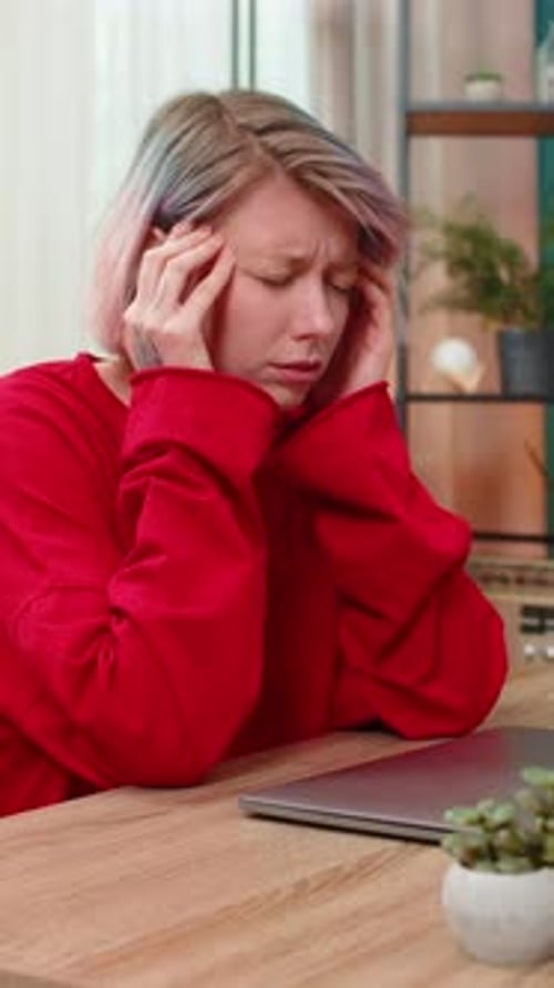 Woman Working at Laptop with Headache