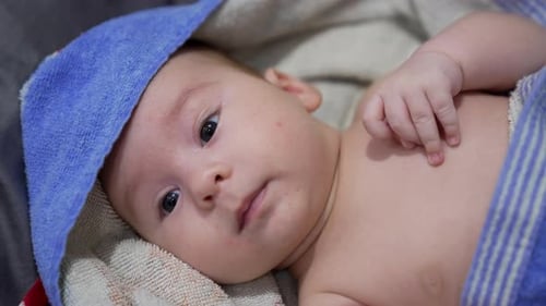 Adorable Baby Wrapped in Towel After Bath