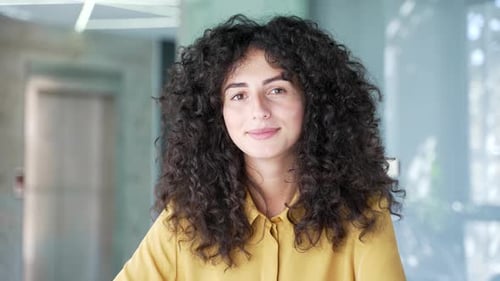 Webcam view. Young adult female employee watching video call training looking at camera at laptop