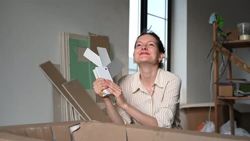 Excited Woman Assembling New Product with Joy