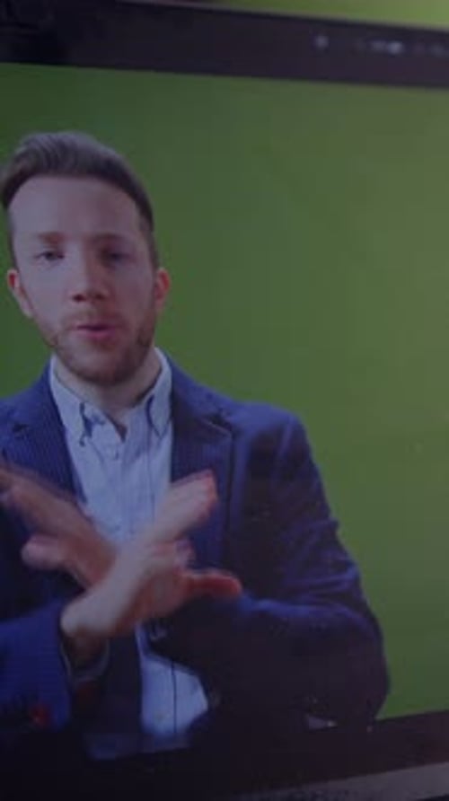 A Professional Speaker Engaging with Their Audience While Utilizing a Green Screen Technique