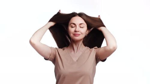 A Beautiful Caucasian Woman Smiles and Wiggles Her Long Shiny Hair