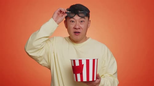 Man Eating Popcorn in 3D Glasses