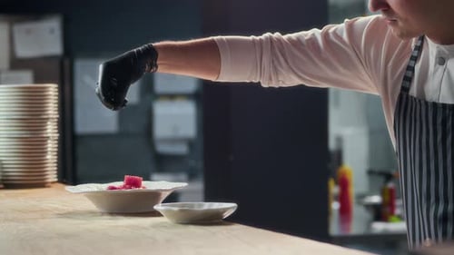 Male Chef Seasoning Tuna Appetizer at Restaurant Kitchen