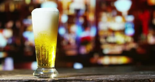 Refreshing Beer Being Poured at Night in the City
