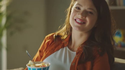 Pregnant Woman Holding Bowl of Fruit in Home