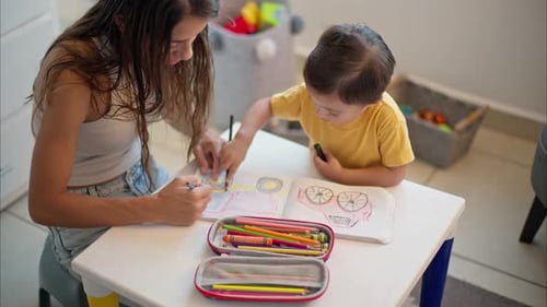 Woman and Toddler Coloring Together Indoors