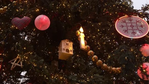 giant hand made ornaments and candles in town square christmas tree at Festive Christmas market in S