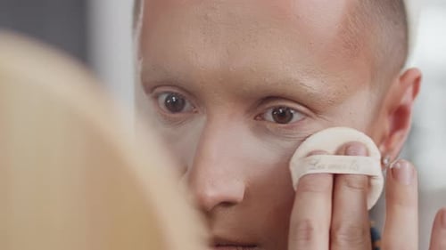 Applying Makeup with Sponge Close Up