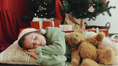 Girl Sleeping Under Christmas Tree with Teddy Bear