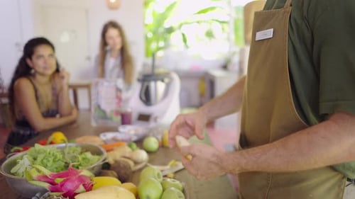 Side View of Unrecognizable Teacher Chef Peeling Banana During Cooking Class