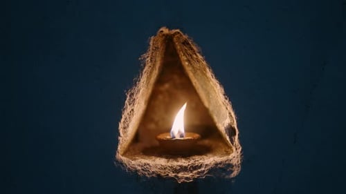 Oil Lamp Flickers in Buddhist Temple Niche Illuminating Night During Vesak Devotees Flames Honor