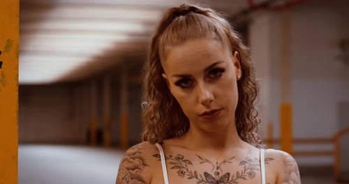 Tattooed Woman Posing in an Urban Location