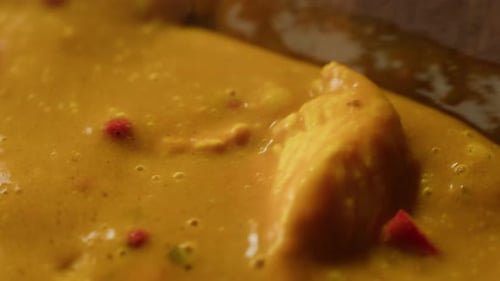 Yellow Boiling Sauce on Pan Closeup Asian Cuisine Concept Curry is a Dish with a Sauce Seasoned with