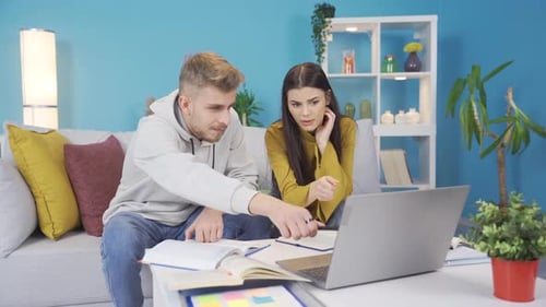 Students Studying Together at Home Using Laptop