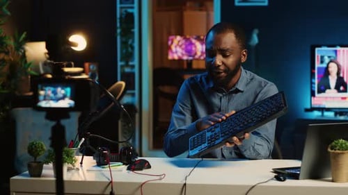 Man Reviews Computer Equipment in Studio