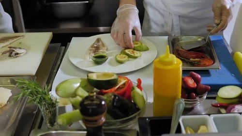 Chef Plating Delicious Fish Dish with Vegetables