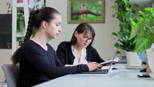 Teen Girl Studying with Adult Woman at Home