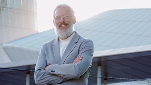 Senior Man Smiling Confidently Outside Modern Building