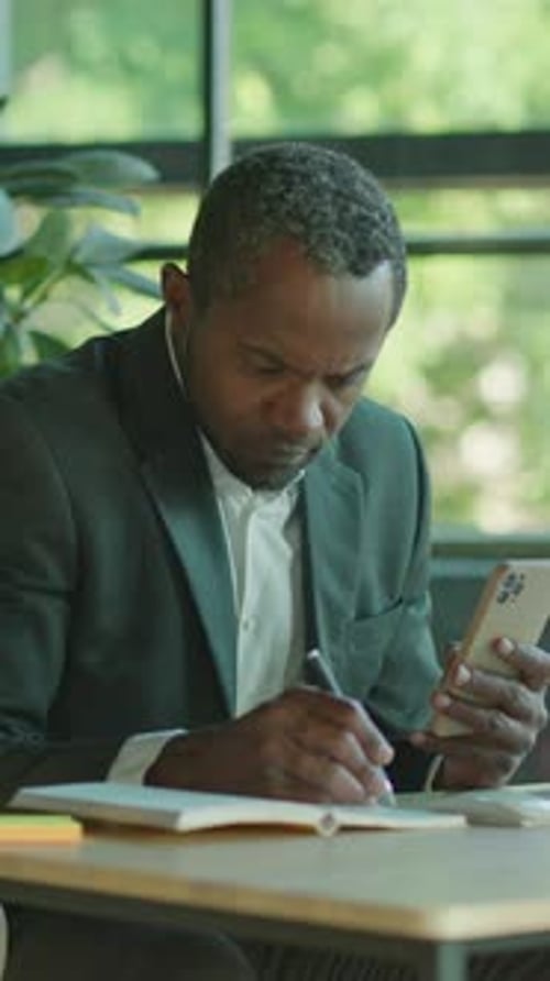 Man in Suit Working at Office Table