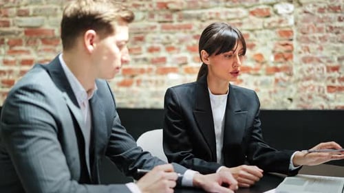 Business Colleagues Discuss Project in Modern Loft Office