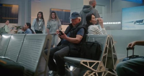 Airport Terminal Diverse Tourists and Passengers Sitting in Departure Lounge of Crowded Airline Hub
