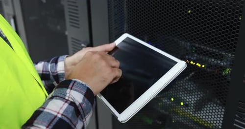 Man Using Tablet in Server Room