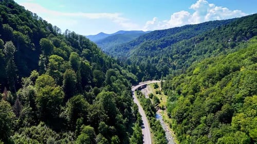 Beautiful mountain valley landscape with winding road.