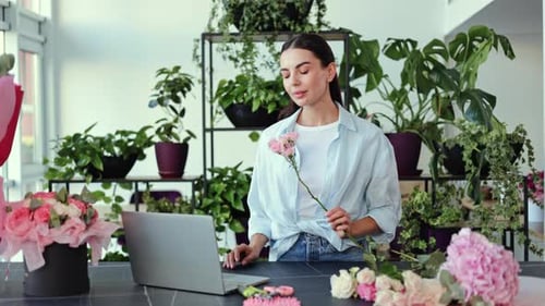 Florist Arranging Flowers in Flower Shop