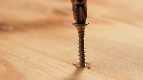 Screwdriver Drills Screw into Lumber Close Up
