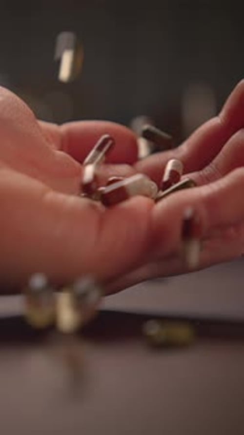 Hand Tossing Green Seeds or Nutritional Supplements for Overall Health and Wellness