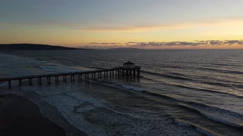 Manhattan Beach Pier at sunset on the coast of California. Aerial view of Pacific Ocean